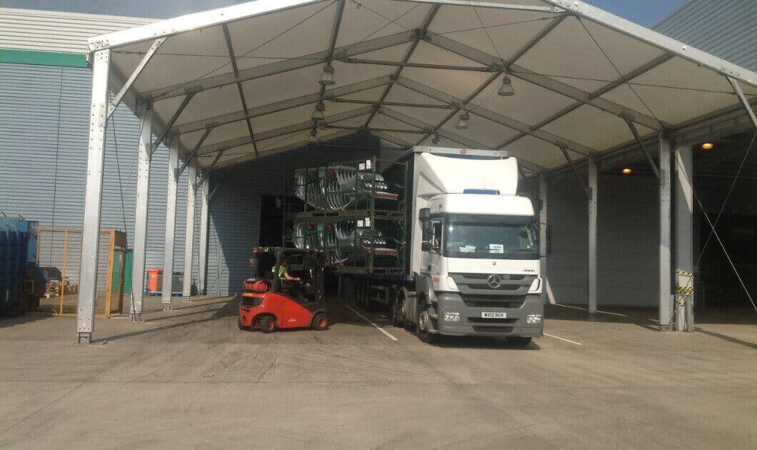 A 15M WIDE TEMPORARY CANOPY PROTECTING THE GOODS FROM THE ELEMENTS